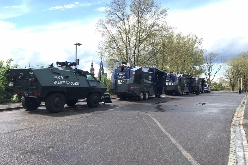Die Polizei hat sich bereits mit mehreren Fahrzeugen - drei Wasserwerfer und ein Räumpanzer - positioniert.