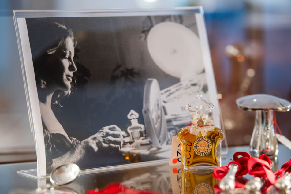 Ein Parfumflacon steht in einer Vitrine vor einem Foto von Romy Schneider. Rund 50 Gegenstände aus dem Besitz von Rosemarie Albach (Romy Schneider) werden am im Auktionshaus Ruef versteigert.