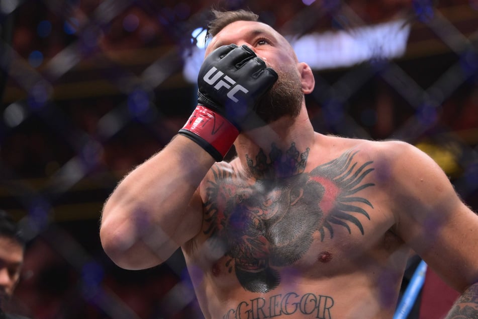 Conor McGregor stands in the ring after injuring his knee during his first kick of UFC 329 on July 11, 2026, in Las Vegas, Nevada, during his return following a five-year layoff.