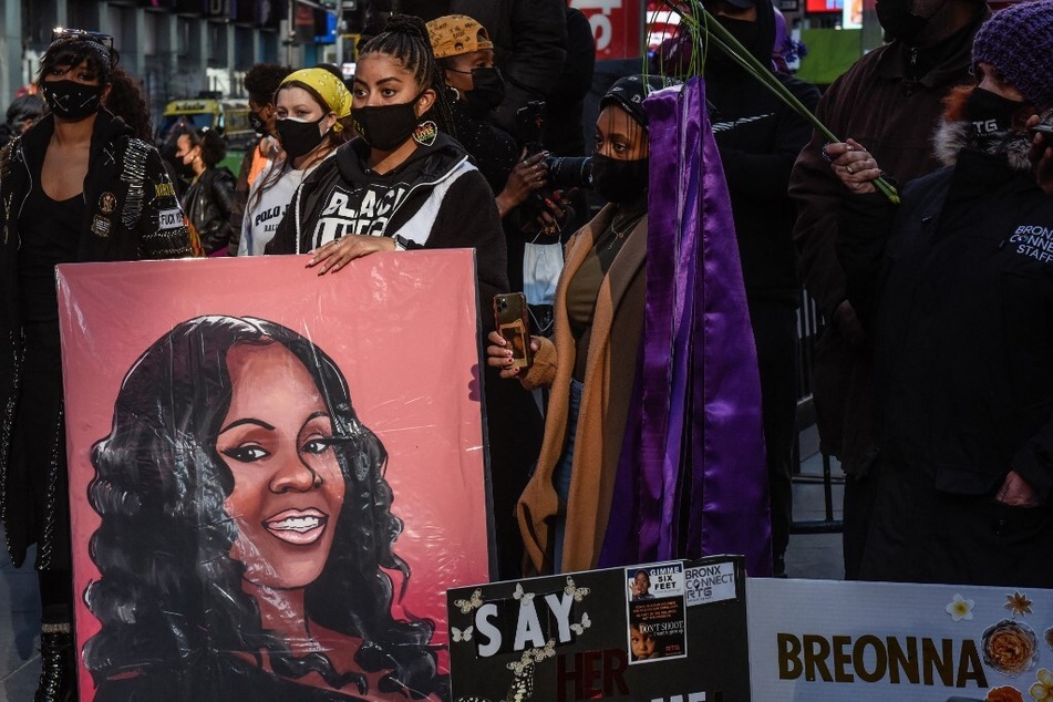 A person holds a sign depicting Breonna Taylor during a protest to mark the one year anniversary of her death, on March 13, 2021, in New York City.