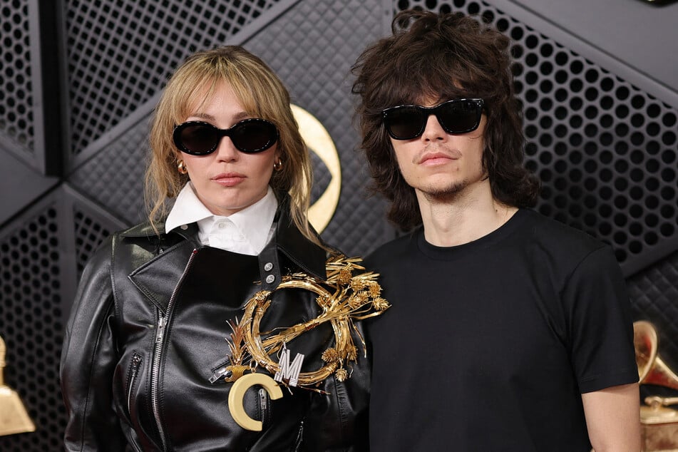 Miley Cyrus (l.) and fiancé Maxx Morando are reportedly planning to host a "smaller and meaningful" wedding.