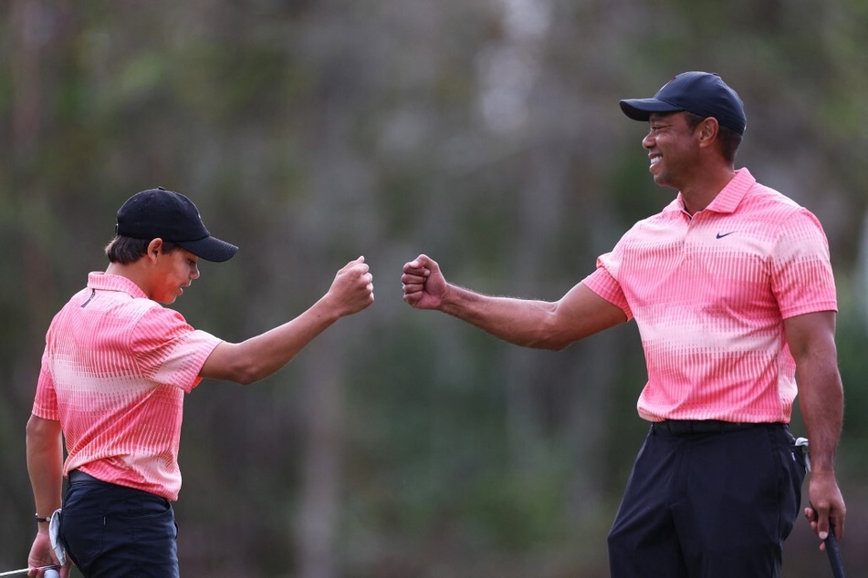 Tiger Woods (r), set to make his return to competition next week following ankle surgery in April, will partner with son Charlie in a parent-child tournament.