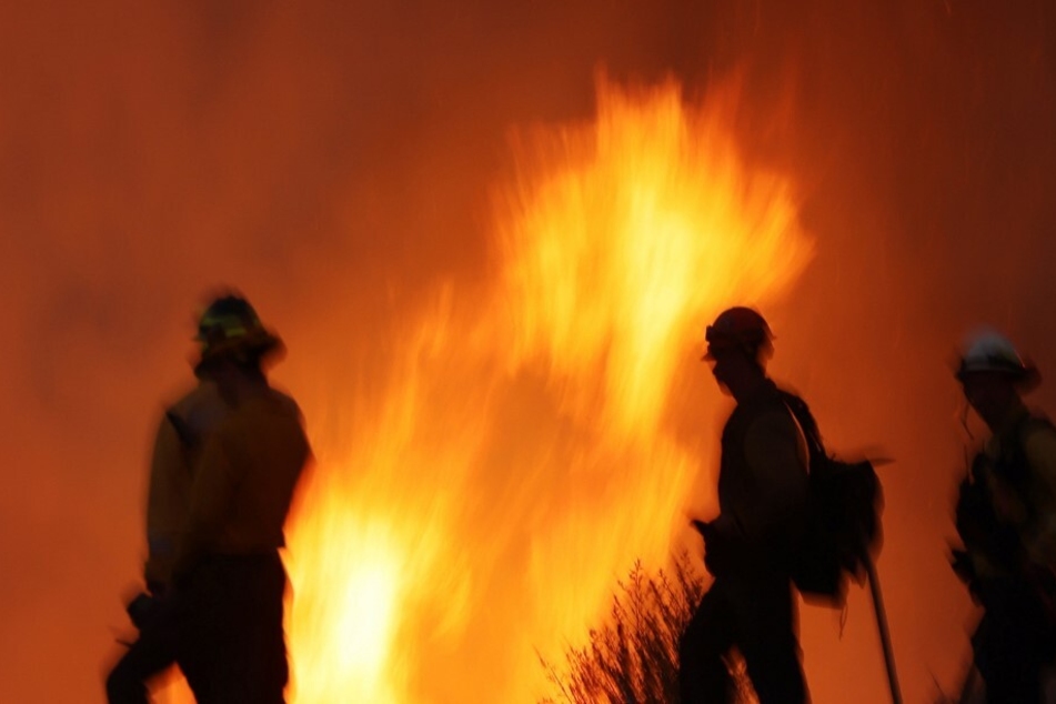 Firefighters monitor and set a controled burn as the Rabbit Fire scorches thousands of acres in California.