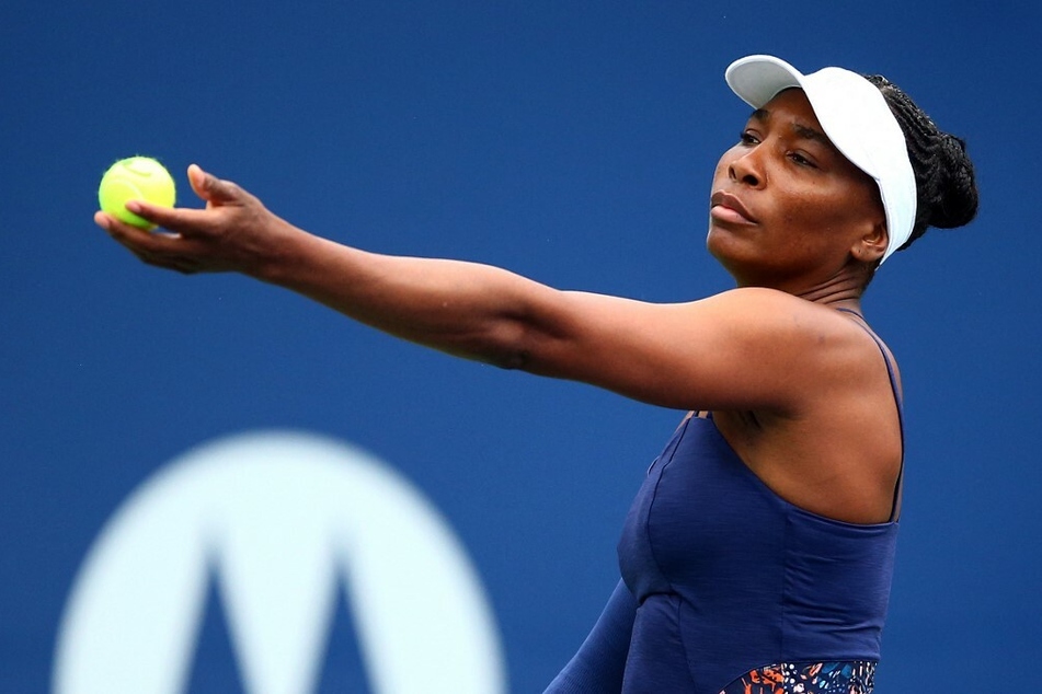 Venus Williams gearing up a service during a tennis match.