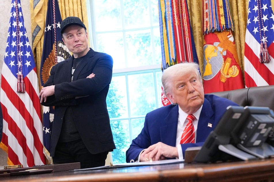 Elon Musk (l.) and President Donald Trump (r.) listen to questions from reporters in the Oval Office of the White House in Washington DC on May 30, 2025.