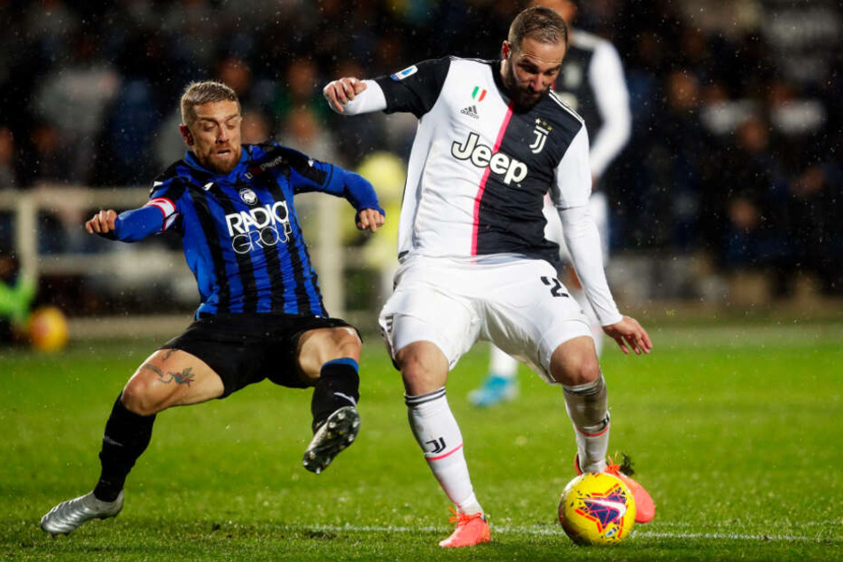 Der 1,65 Meter kleine Kapitän Papu Gómez (l.) ist das Herz des Bergamo-Spiels. Hier attackiert er Juve-Star Gonzalo Higuain.