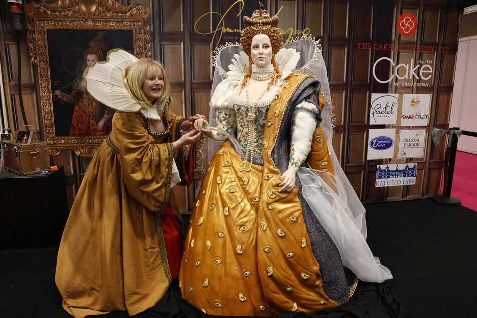 Cake artist Emma Jayne puts the final touches to her Queen Elizabeth I creation during this year's Cake International show at the NEC in Birmingham.