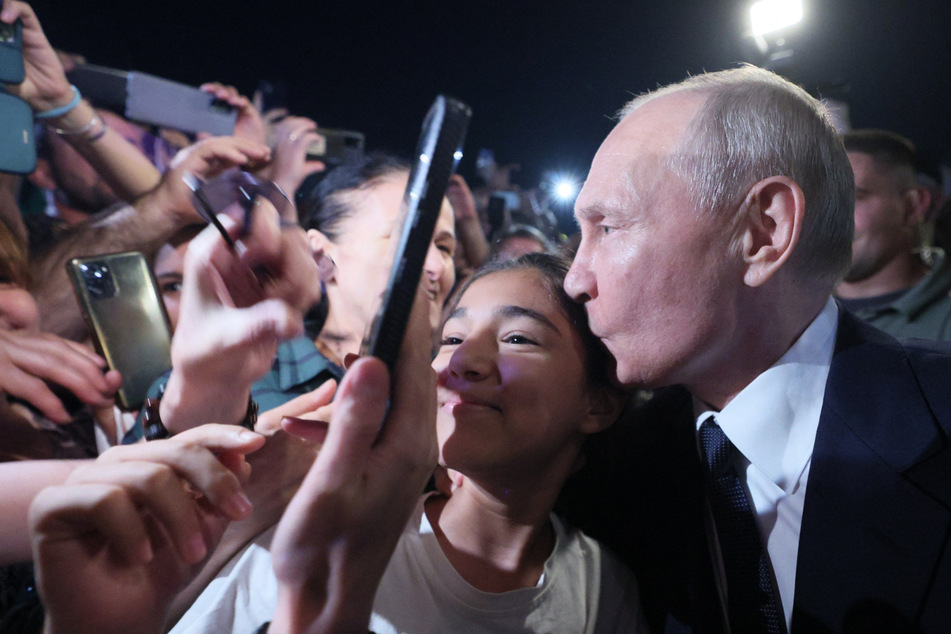 So kennt man ihn gar nicht: Wladimir Putin (70) herzt eine junge Frau und posiert für ein Selfie.