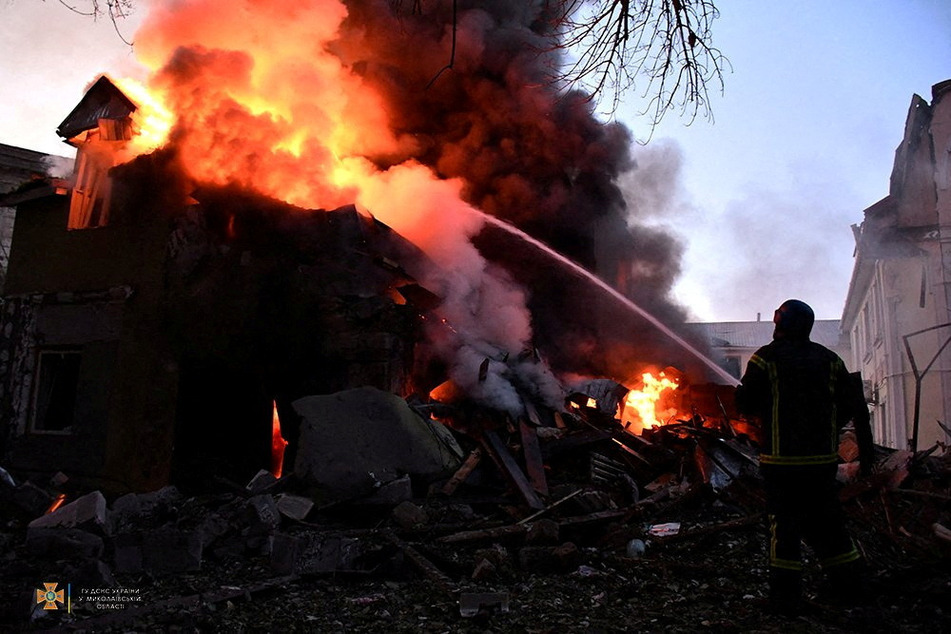 Russian attacks on Ukraine continue as firefighters battle a blaze in Mykolaiv, where a missile struck a residential building.