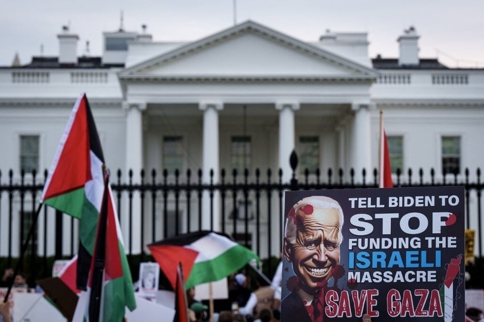 Protesters wave Palestinian flags in front of the White House as they call on the Biden administration to stop funding Israel's bombardment and ground invasion of Gaza.