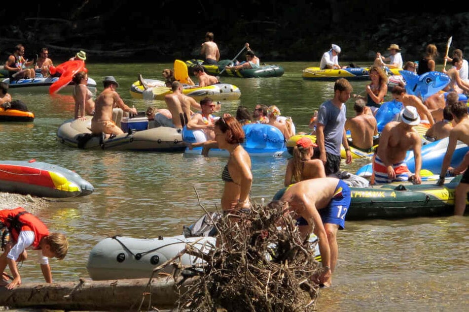 An heißen Tagen sind viele Menschen mit dem Schlauchboot auf der Isar unterwegs.