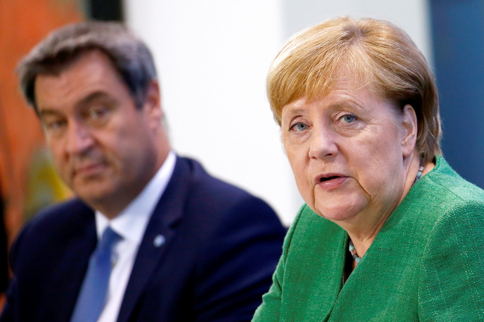 Bundeskanzlerin Angela Merkel (CDU) sitzt mit dem bayerischen Ministerpräsidenten Markus Söder (CSU) bei einer Pressekonferenz im Kanzleramt.