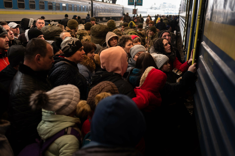 People struggle to board a train in Lviv, western Ukraine.