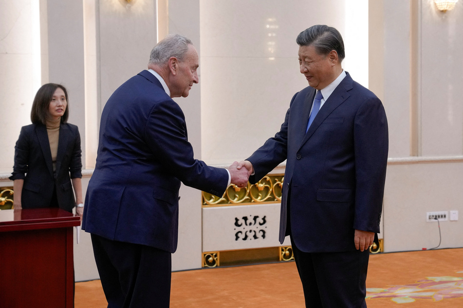Visiting US Senate Majority Leader Chuck Schumer is greeted by Chinese President Xi Jinping before their bilateral meeting at the Great Hall of the People in Beijing, on October 9, 2023.
