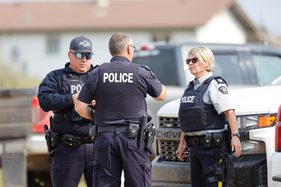 Royal Canadian Mounted Police officers at James Smith Cree Nation talk after multiple people were killed and injured in a stabbing spree on the reserve and in the nearby town of Weldon.