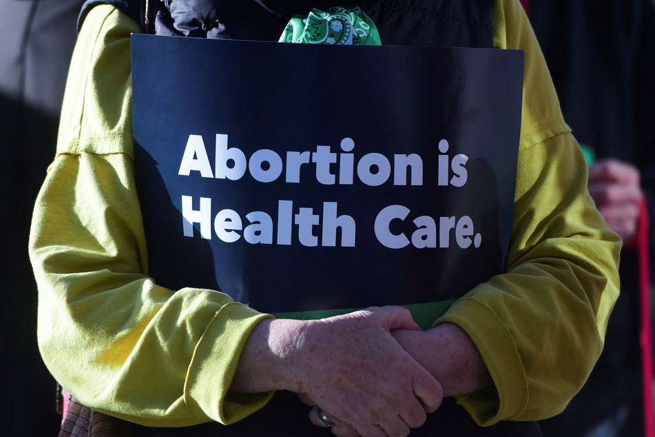A demonstrator holds a sign reading "Abortion is Health Care" during a Women's March protest.