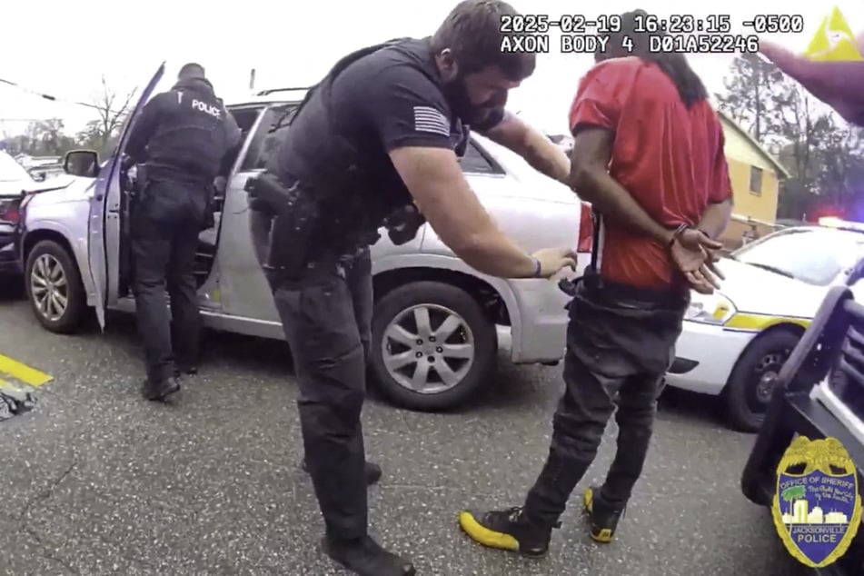 A police officer searches William McNeil Jr. after he was pulled over during a traffic stop in Florida on February 19, 2025.