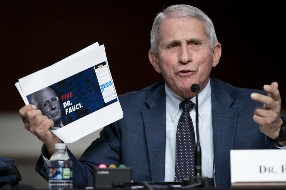 Fauci held up print-outs of Paul’s Senate campaign website, which have pictures of Fauci next to the text "Fire Dr. Fauci."