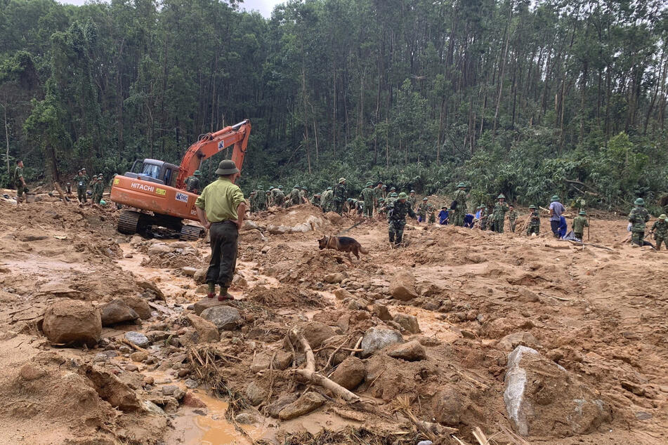 Rescue workers are recovering the remains of army officers buried in a landslide in Thua Thien-Hue province, Vietnam.