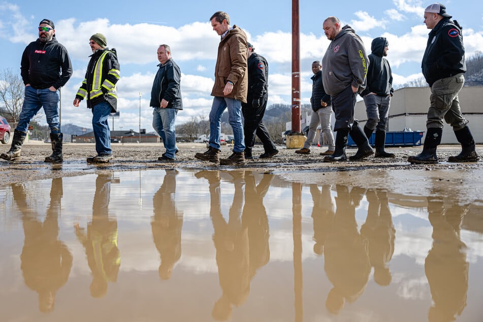 Kentucky Governor Andy Beshear walks with local emergency responders following rain storms that caused flooding on February 17, 2025 in Pikeville, Kentucky.