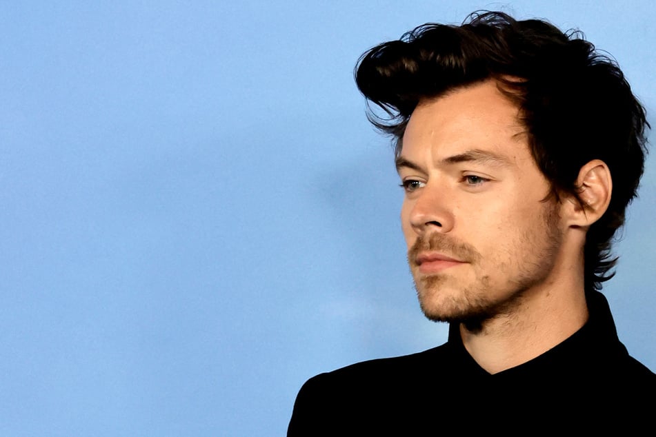Why is Harry Styles reportedly stuck at home?
