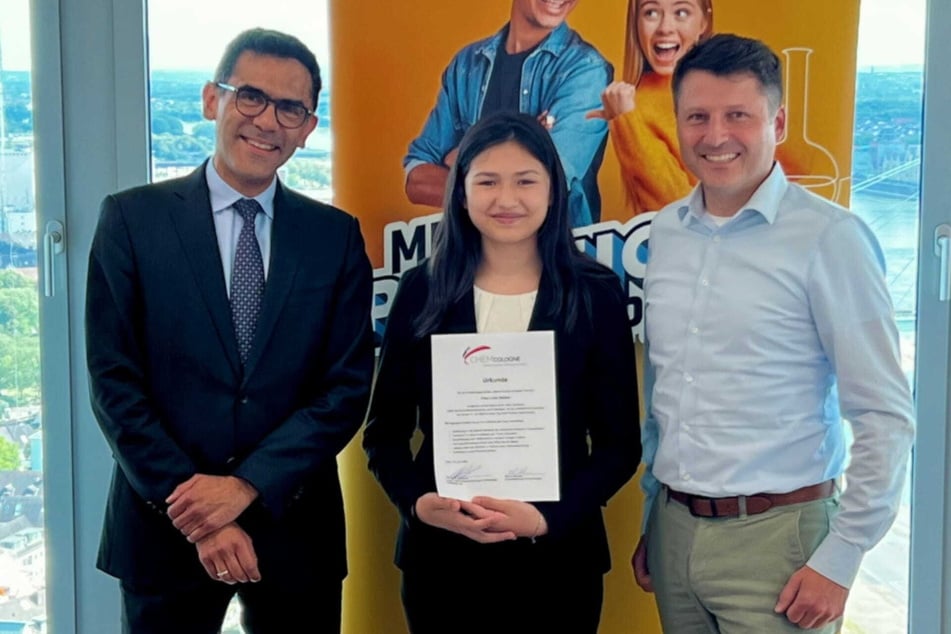 Lina Heider (11) erhielt eine Urkunde von Harry Zumaqué (L.), Leiter für Geschäftsentwicklung und KI-Strategie bei LANXESS und Daniel Wauben, Geschäftsführer von ChemCologne, für die erfolgreiche Teilnahme am Aktionstag.