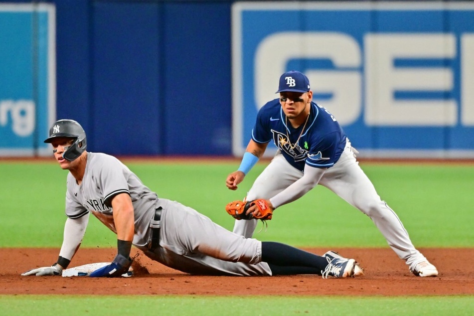 Aaron Judge #99 of the New York Yankees steals second base against Isaac Paredes #17 of the Tampa Bay Rays.