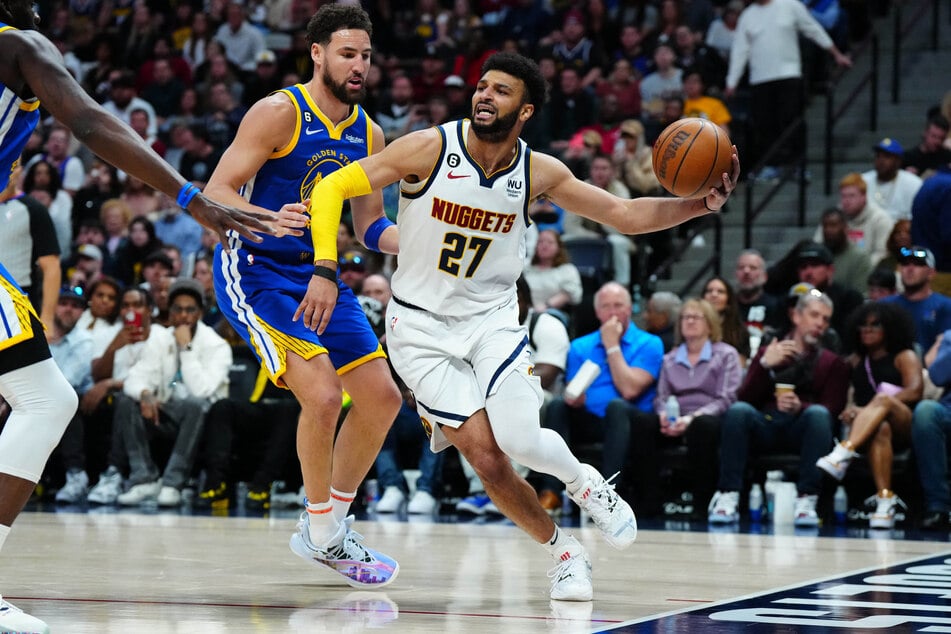 Denver Nuggets guard Jamal Murray drives past Golden State Warriors guard Klay Thompson in the second half at Ball Arena.