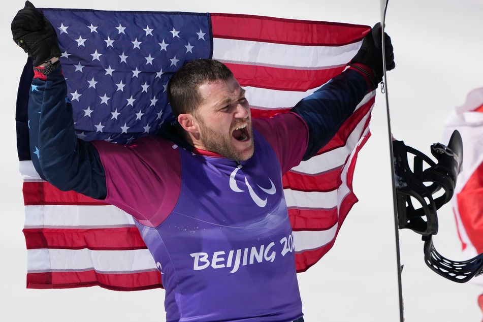 Mike Schultz of the United States celebrates after the Para Snowboard Men's Cross, where he won a silver medal.