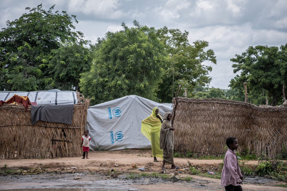 Children watch as aid workers arrive at the Korsi refugee camp in Birao, Central African Repubic, on August 10, 2024.