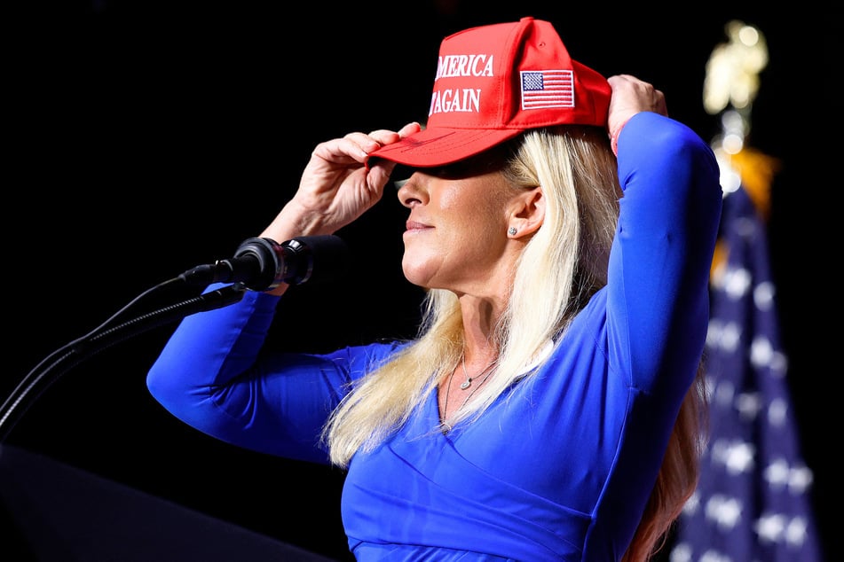 Marjorie Taylor Greene donning a MAGA hat while addressing a campaign rally with Donald Trump at the Forum River Center in Rome, Georgia on March 09, 2024.