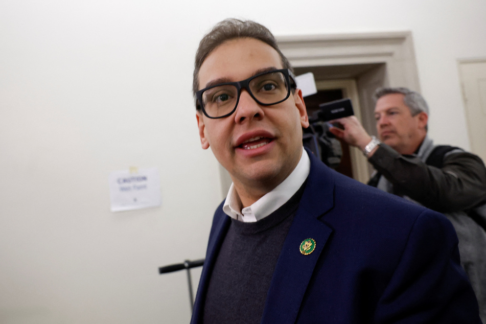 New York Rep. George Santos talks with reporters and photographers outside his congressional office in Washington DC.