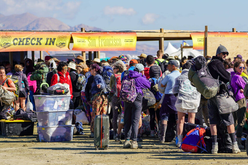 Burning Man festival attendees begin exodus in drenched desert