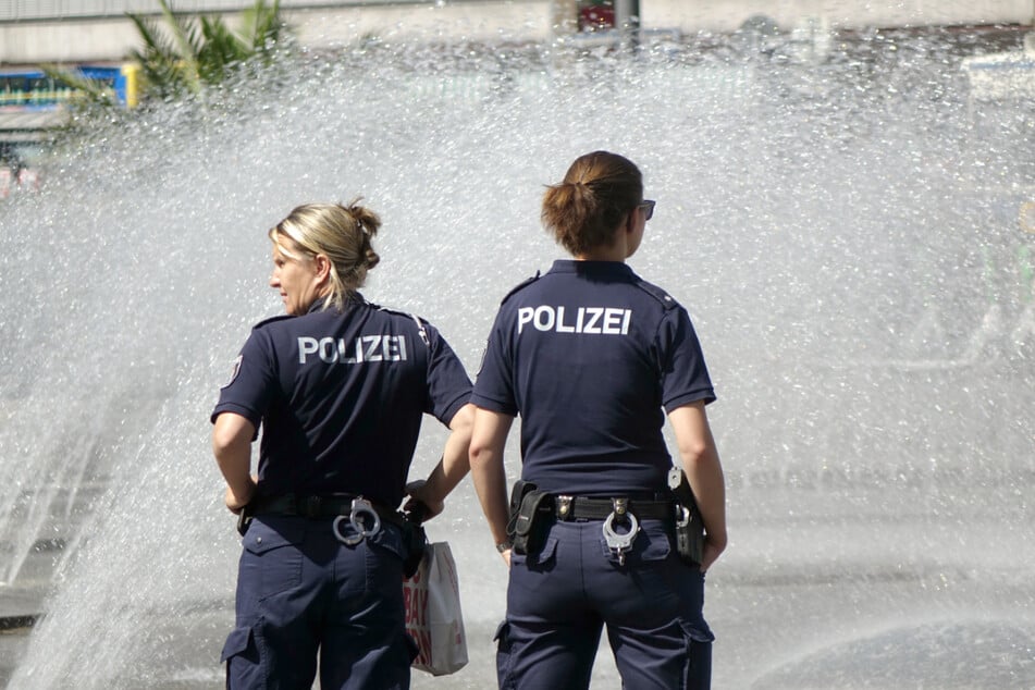 Polizist sein in diesen Tagen ist ein schweißtreibender Job. Da tut etwas Abkühlung, wie hier am Springbrunnen, gut.
