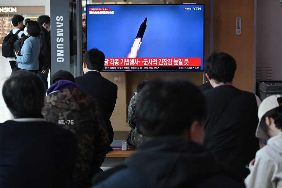 People watch a television screen showing a news broadcast with file footage of a North Korean missile test, at a train station in Seoul on Tuesday.