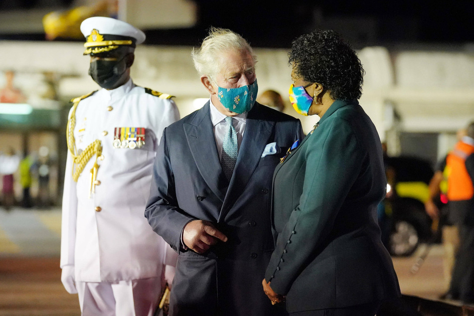 Prince Charles (c.) chats with Barbados Governor General Sandra Mason (r.), soon to be the island nation's president.