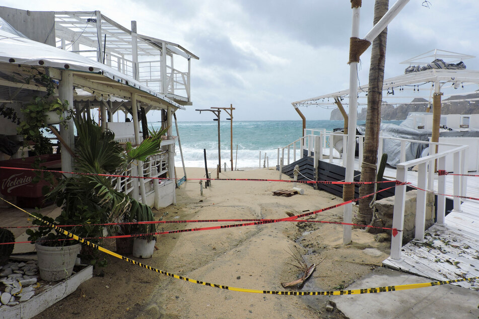 Caution tapes prevent the passage at El Medano beach as Hurricane Hilary hits Mexico's Baja California peninsula, in Cabo San Lucas, Mexico.