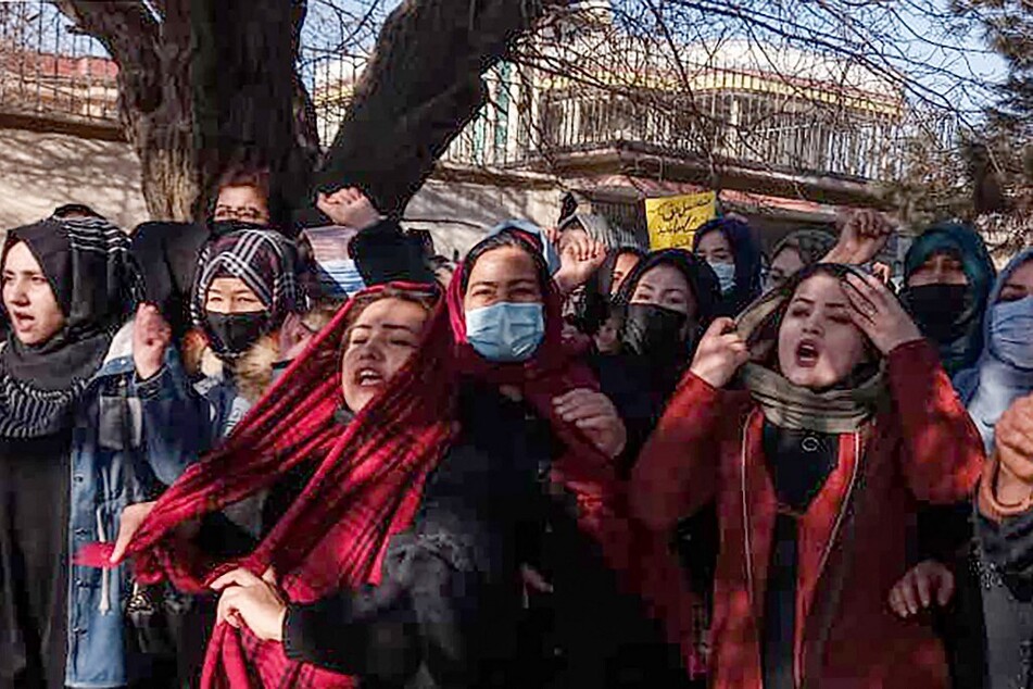 Afghan women chant slogans to protest against the ban on university education for women, in Kabul.