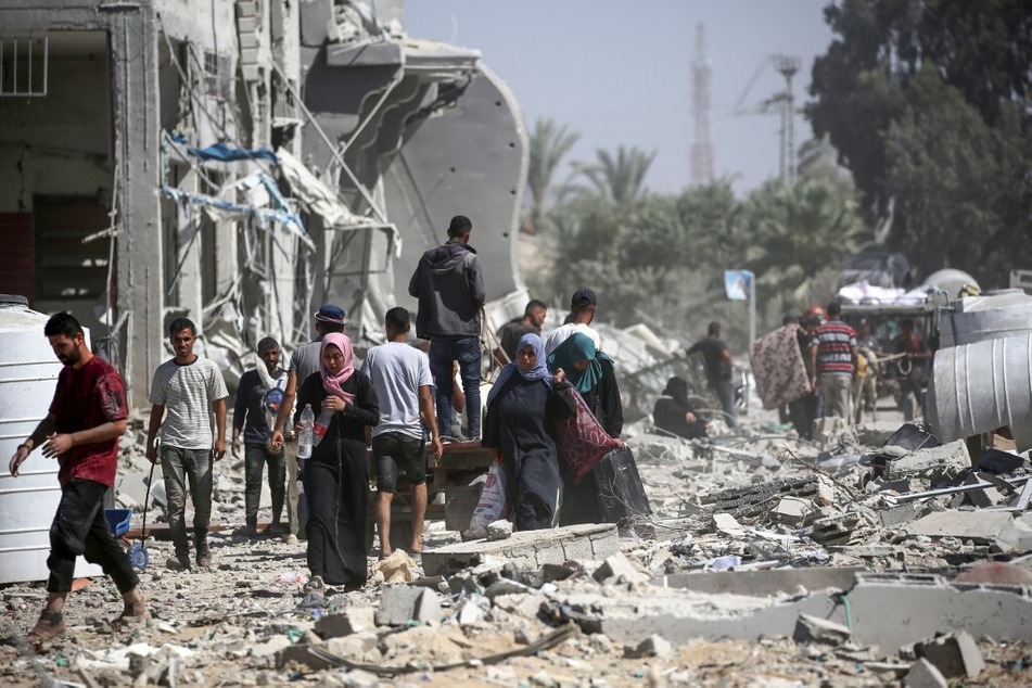 Palestinians return briefly to eastern Deir el-Balah in the central Gaza Strip to check on property and carry away some items they were able to salvage amid the devastation.