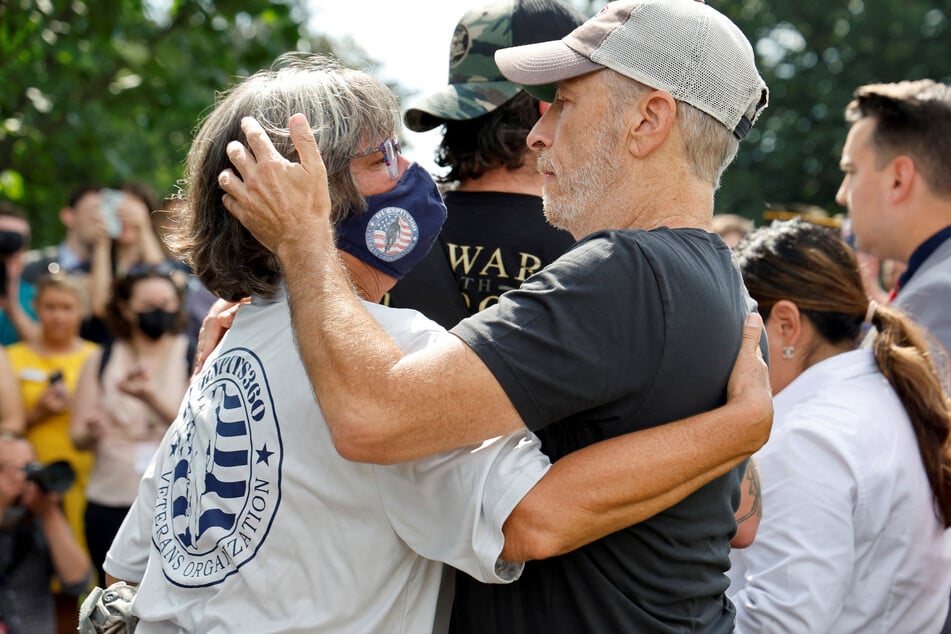 Stewart and a fellow activist for veterans' healthcare embrace.