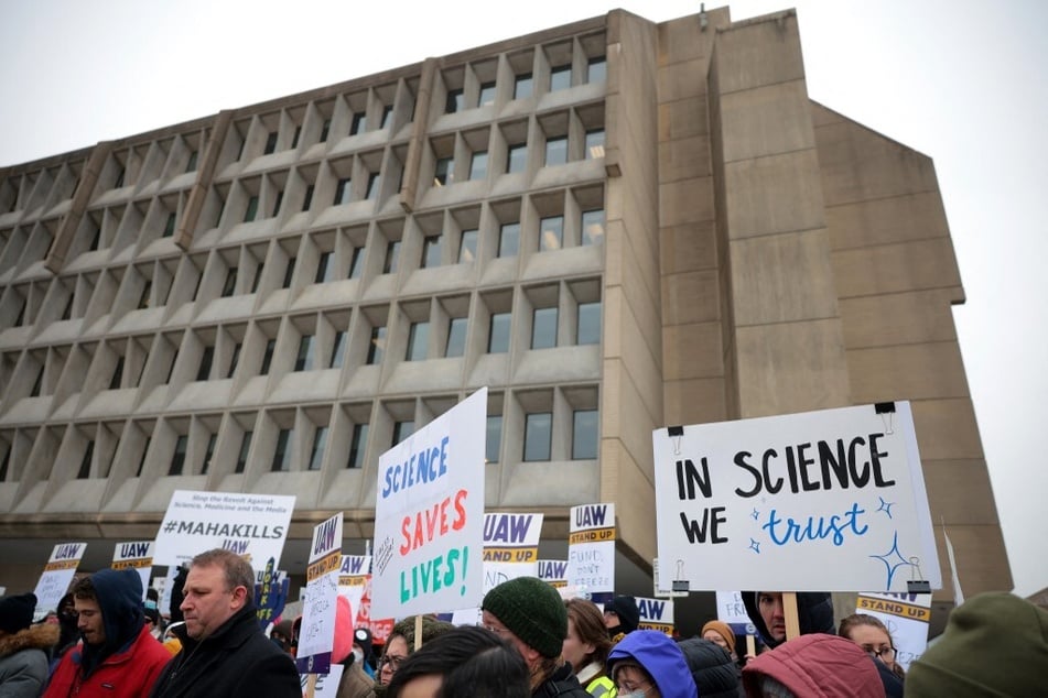 Federal workers and supporters rally outside of the Department of Health and Human Services in Washington DC.