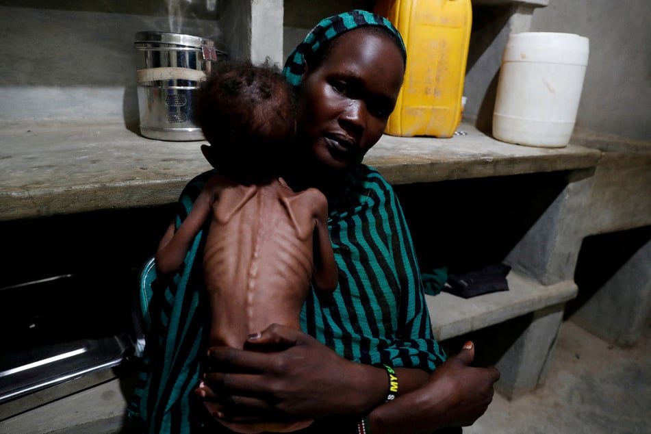 A Sudanese woman holds her severely malnourished child at the pediatric ward of the Mother of Mercy Hospital in Gidel, South Kordofan.