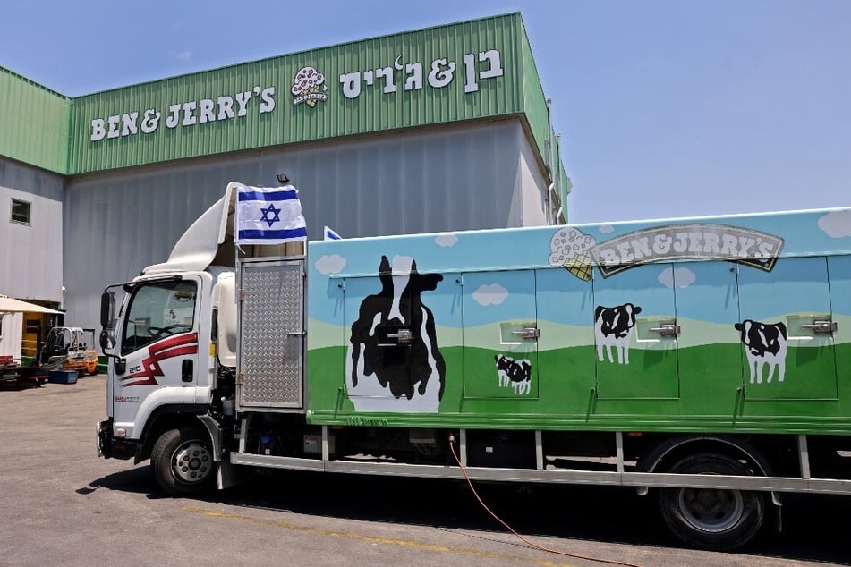 An Israeli flag is set atop a delivery truck outside a Ben &amp; Jerry's factory in Be'er Tuvia, Israel, in July 2021.