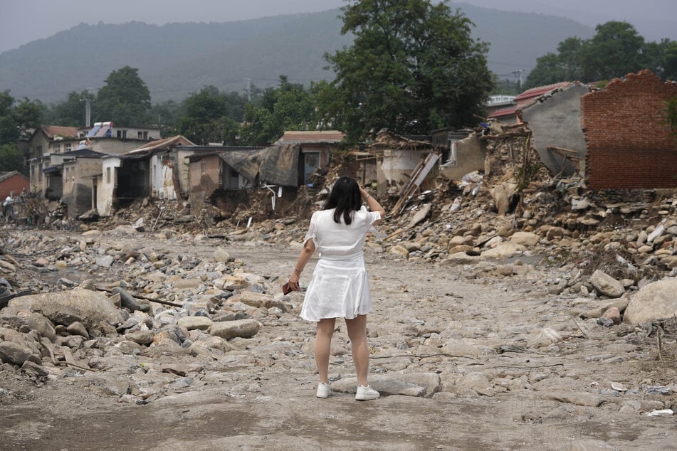 Eine Frau findet ihr Haus nicht mehr, nachdem das Hochwasser das Dorf Nanxinfang am Stadtrand von Peking verwüstet hat.