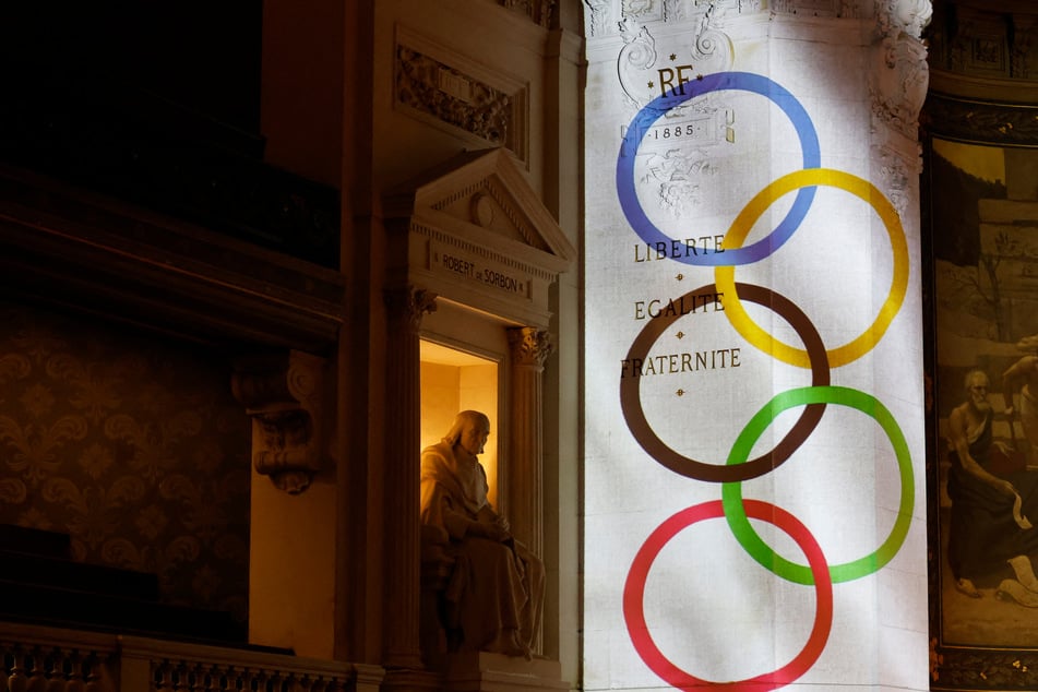 Olympic rings are projected onto a wall during a tribute evening to Pierre de Coubertin and the creation of the modern Olympic Games at the Sorbonne University in Paris on June 23, 2024.