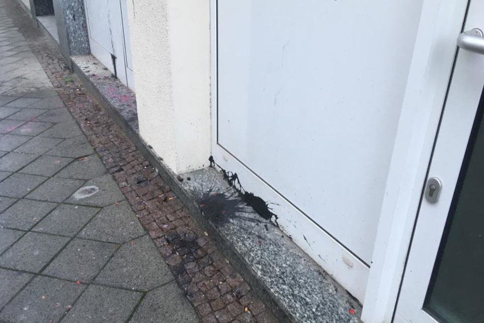 Vor den Fenstern liegen geplatzte Farbbeutel.