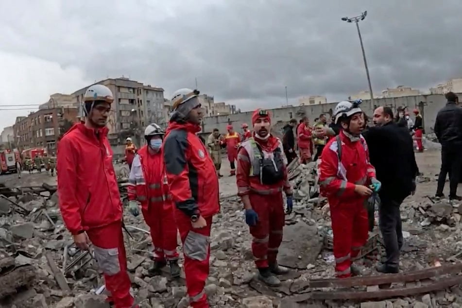 Members of the Iranian Red Crescent Society work at the site of a strike in Tehran on March 31, 2026.