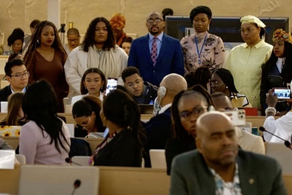 Miles Henderson and members of the International Civil Society Working Group Youth Sub-Committee stand together as they deliver the first-ever Youth Declaration before the United Nations Permanent Forum on People of African Descent.