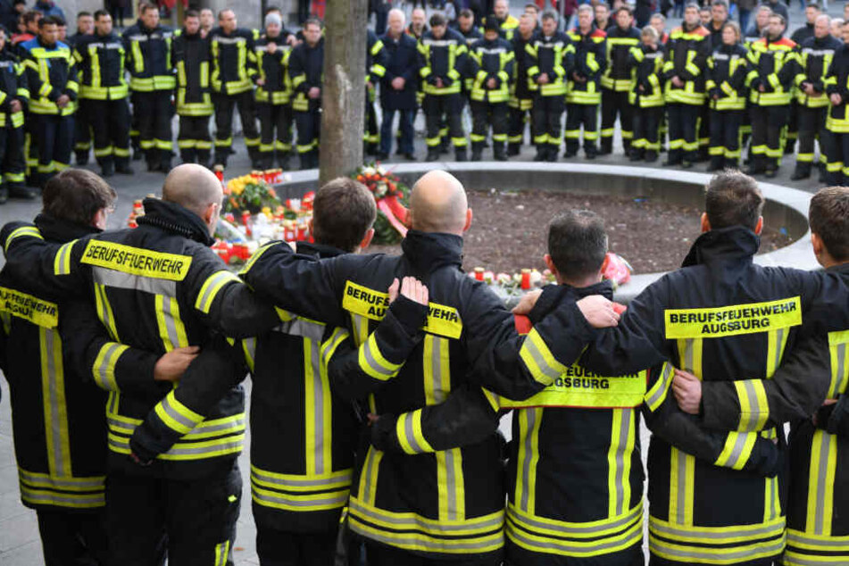 Am Königsplatz trauern Feuerwehrmänner um den verstorbenen Kameraden.