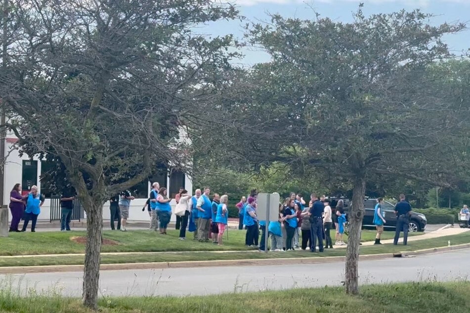 Police officers speak to Walmart employees after a stabbing incident occurred in Traverse City, Michigan, on July 26, 2025